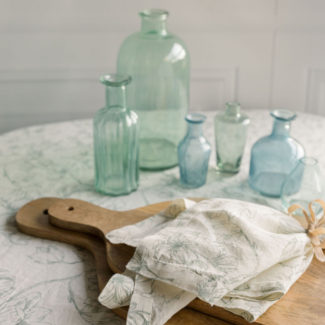 Light blue and white linens with matching napkin set and assorted blue glass set