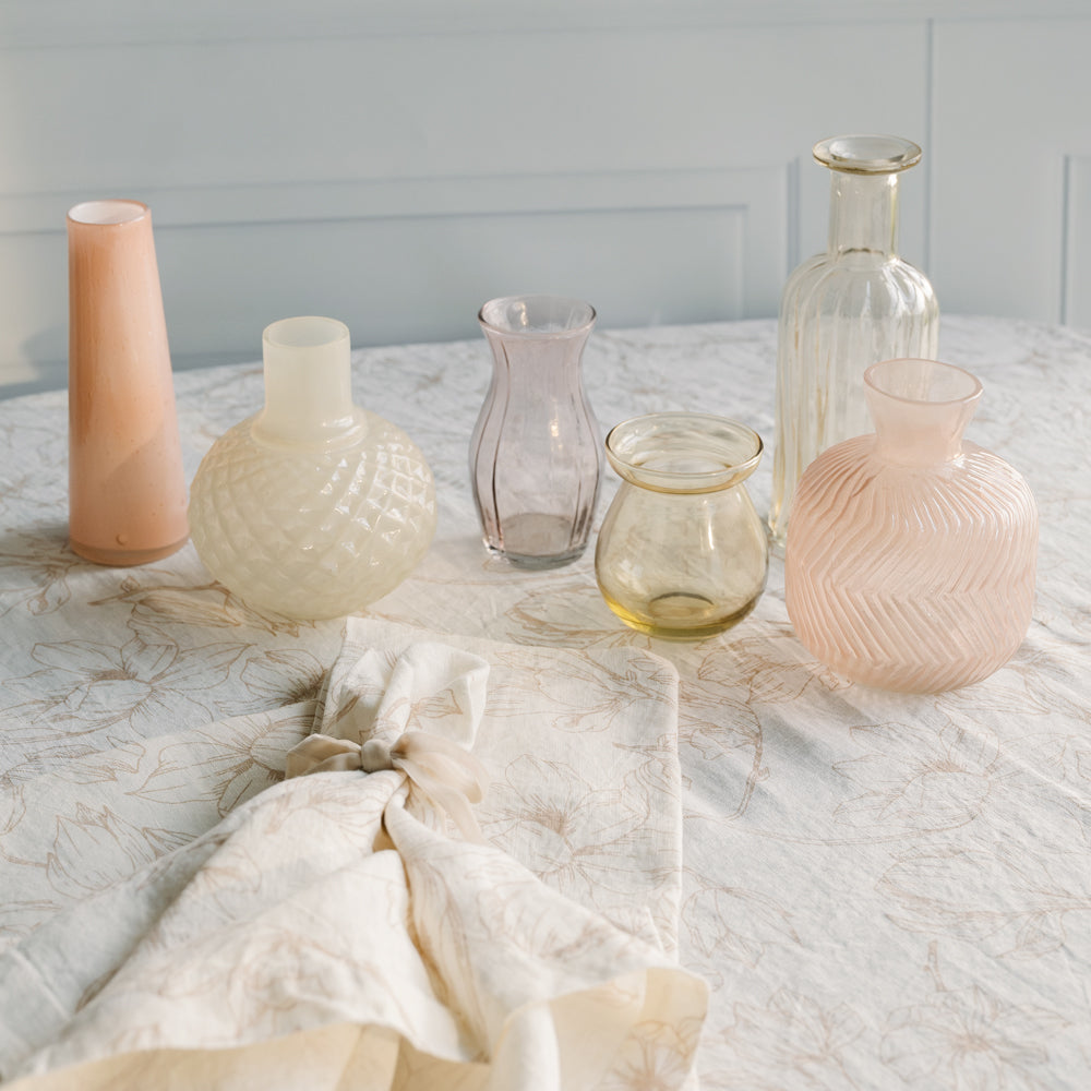 Pink floral linens and matching glass vase assortment