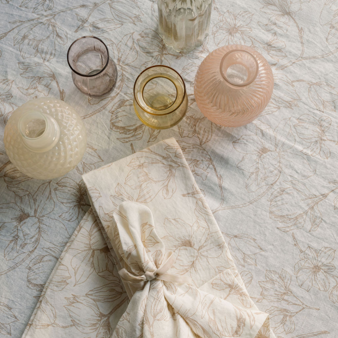Pink floral linens and matching glass vase assortment