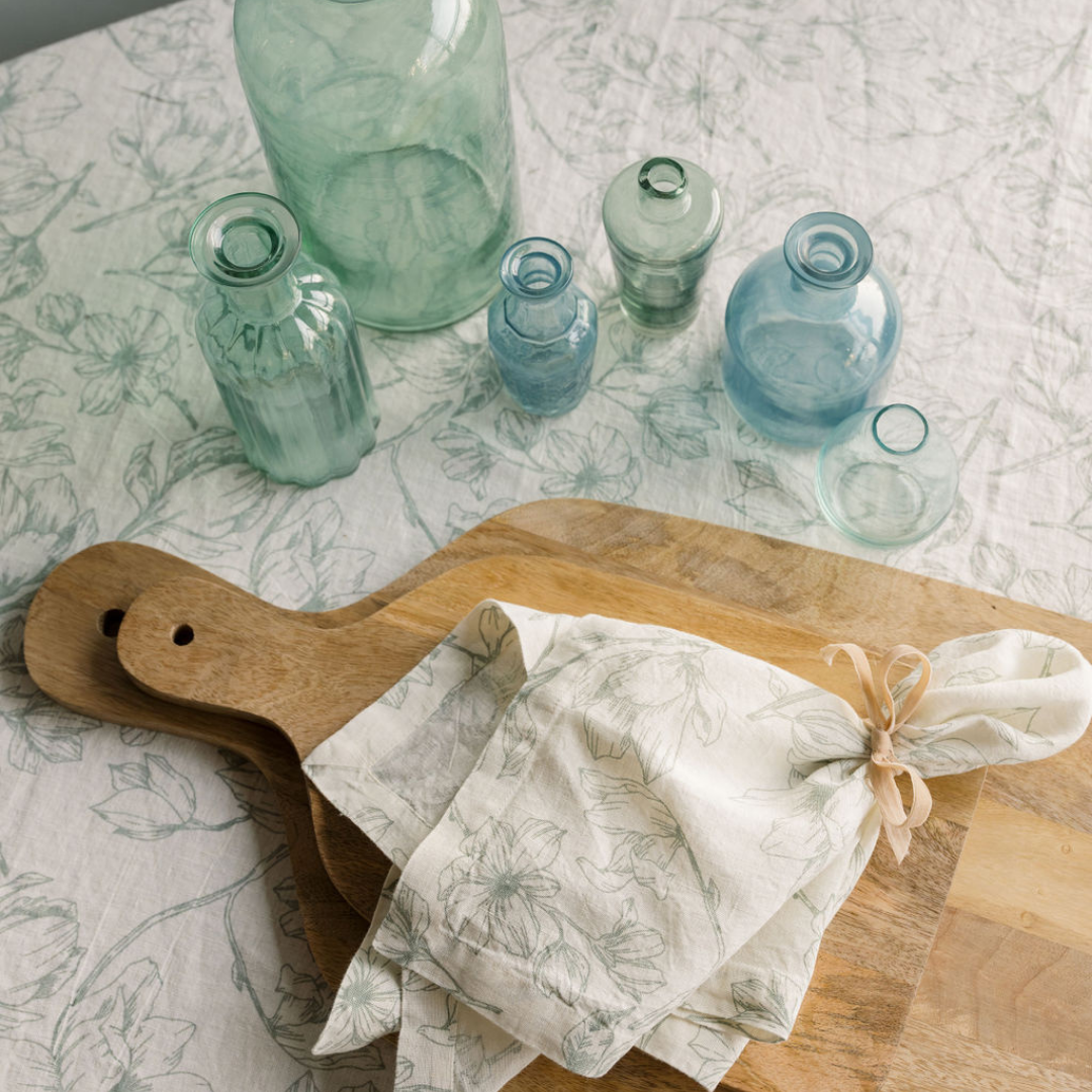 Light blue and white linens with matching napkin set and assorted blue glass set