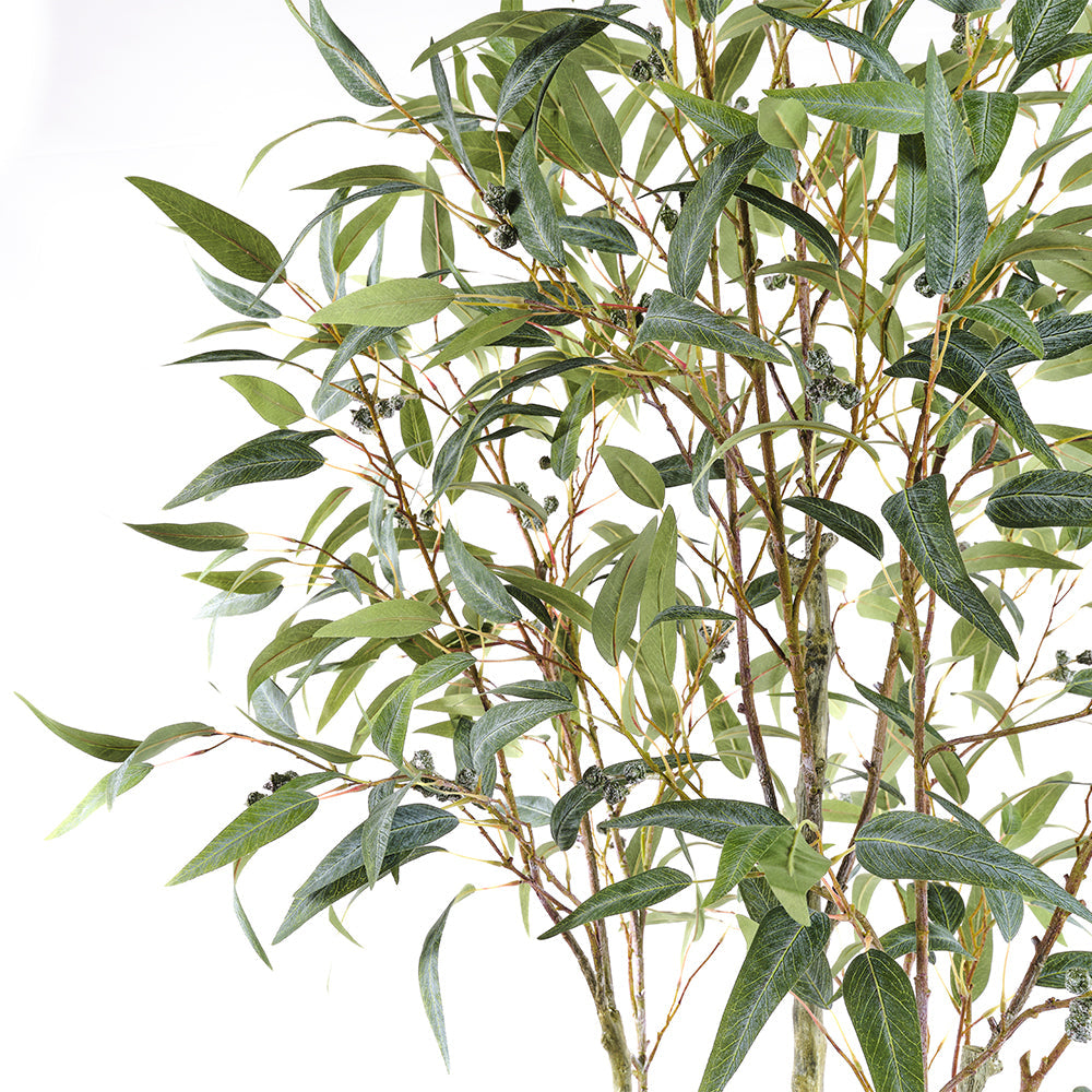 Close up of the handpainted tree trunks of the  CG Hunter Artificial Willow Eucalyptus Tree 7' elegantly showcased with a modern Artisan Planter.