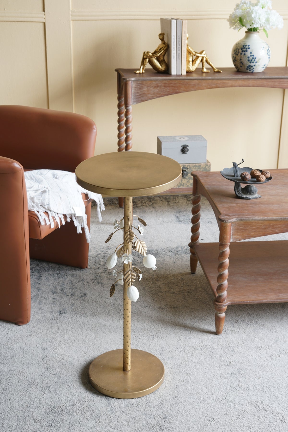 Round Iron Side Table with Gold and White Floral Accents and Cement Base