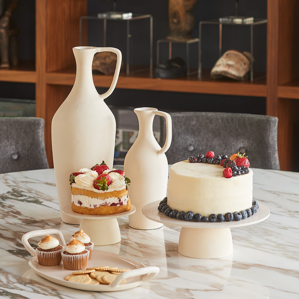 Close up of matching creme pitchers